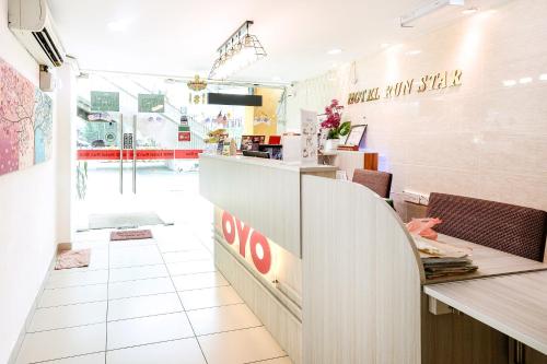 a restaurant with a counter with a restaurant sign on the wall at OYO 805 Hotel Run Star in Kuala Lumpur