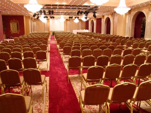 an empty hall with rows of chairs and a red carpet at Pyramisa Suites Hotel Cairo in Cairo