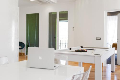 a white dining room with white tables and chairs at President Plaza Vip Suite Spa by Babylon Stay in Naples