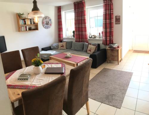 a living room with a table and a couch at Ferienwohnung Hof Maiweg in Alt Schönau