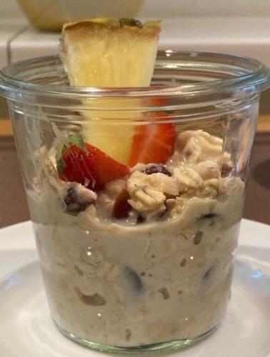 a jar of food with fruit and nuts on a plate at City Hotel Freiburg in Freiburg im Breisgau