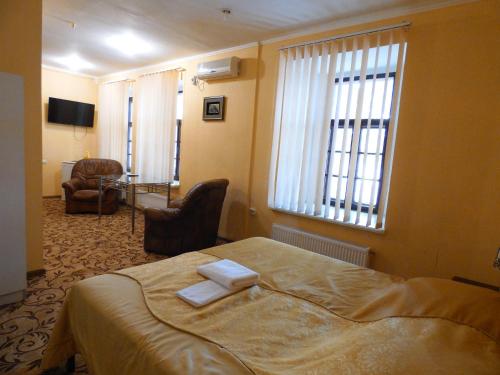 a hotel room with a bed with two towels on it at Na Admirala Makarova in Mykolaiv