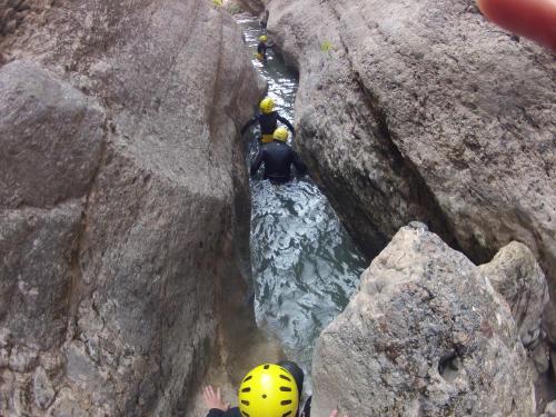 a group of people on a river between rocks at Hotel Florido in Sort
