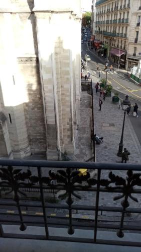 a view of a city street from a balcony at Hôtel De La Perdrix Rouge in Paris
