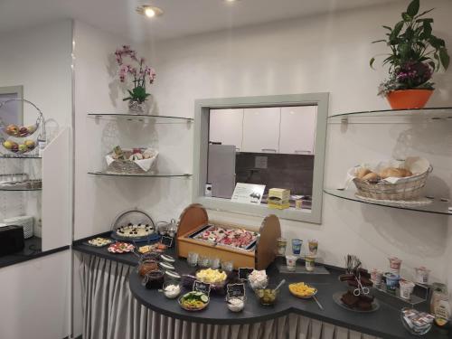 a table with food on it in a room at Hotel Regina in Würzburg