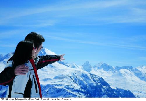 a man and a woman standing on top of a mountain at Alpine Lodge Klösterle am Arlberg in Klösterle am Arlberg