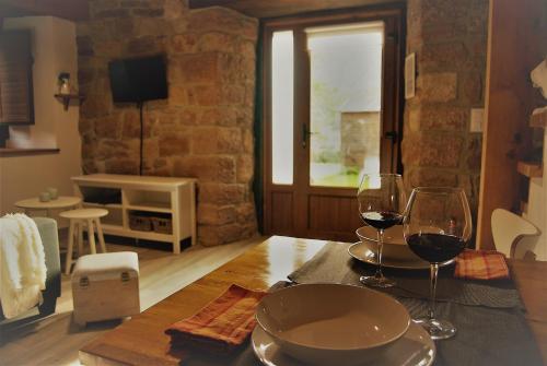 a table with two glasses of wine on it at Apartamentos El Abertal in Navedo