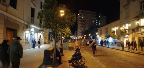 a group of people walking down a street at night at Mary’s House in Torre del Greco