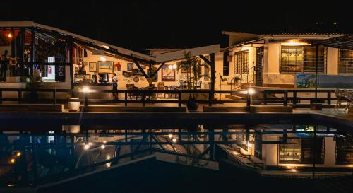 a house at night with a pool in front of it at Hotel Tilapia in Mwanza