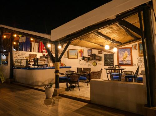 a restaurant with a table and chairs in a room at Hotel Tilapia in Mwanza