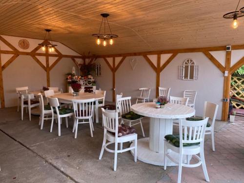 a patio with tables and chairs in a building at Agro na Wapniarni in Białla