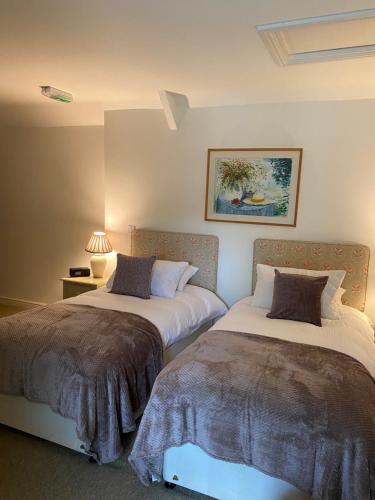 two beds sitting next to each other in a bedroom at THE RED LION in Cricklade
