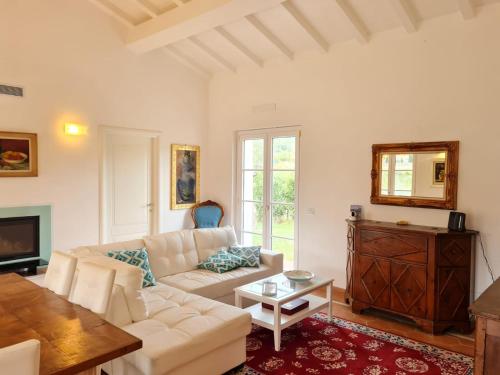 a living room with a white couch and a table at B&B Luna Nuova in Sarzana