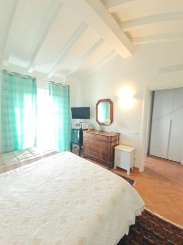 a bedroom with a bed and a dresser and a mirror at B&B Luna Nuova in Sarzana