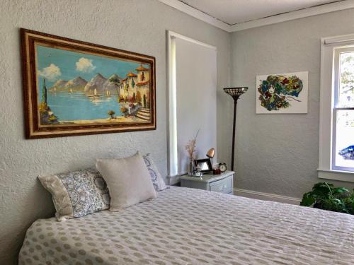 a bedroom with a bed with a painting on the wall at Comfy and Spacious Suite with Free Parking - 2G in Miami