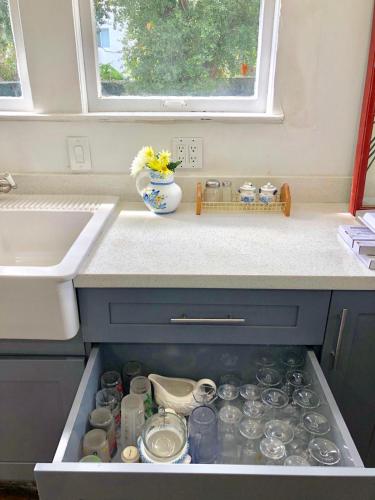a drawer filled with dishes and a vase on a kitchen counter at Comfy and Spacious Suite with Free Parking in Miami