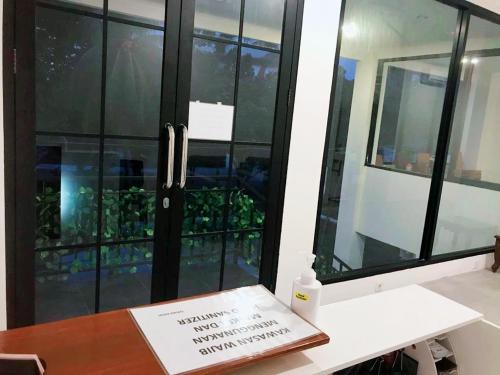 a book sitting on a desk in front of a window at NYENYAK MRT Lebak Bulus Simatupang in Jakarta