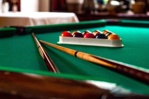a pair of cue balls on a pool table at Hotel Römerhof in Baden-Baden