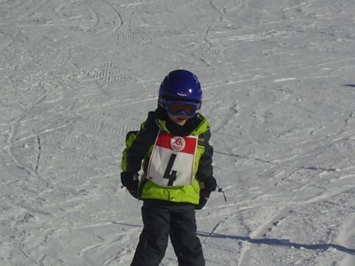 a young child is standing in the snow at Apart Raphael in Niederthai