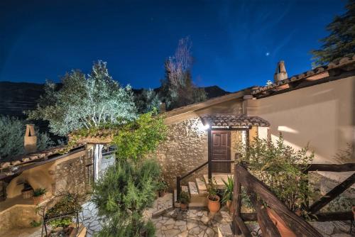 a house with a staircase leading to a door at night at Ampelos Estate in Akrata