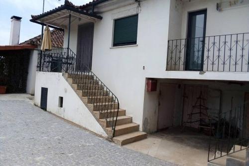 a stairway leading to a white building with a staircase at Casas da Nazaré2 in Ponte de Lima