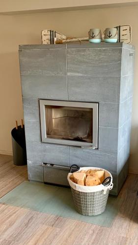 a fireplace with a basket of bread in front of it at Haus am See in Möhnesee