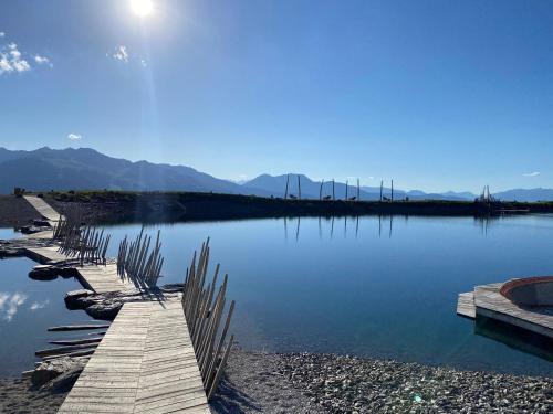 a wooden pathway across a lake with mountains in the background at Ferienwohnung Schiestl in Zell am Ziller
