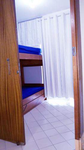 a room with a bedroom with a bed and a door at Eldorado Flat Service in Caldas Novas