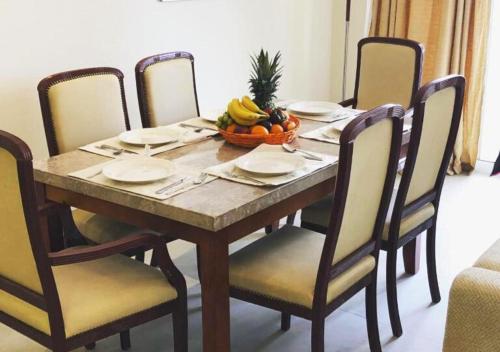 a dining room table with a bowl of fruit on it at Holiday Home 3 bedroom Seaview in Ras al Khaimah