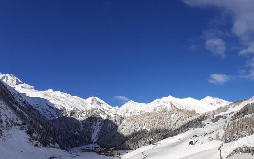 a snowy mountain range with snow covered mountains at Landhaus Mader Hintertux in Tux
