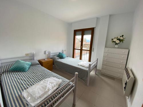 a bedroom with two beds and a window at Altur 5 Jaca in Jaca