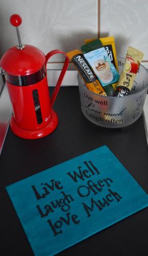 a table with a red cup and a sign on it at Agape C-52 in Trebinje
