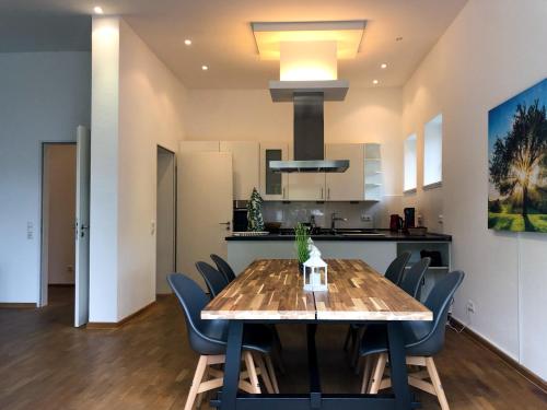 a dining room and kitchen with a table and chairs at Hotel Kloster Eberbach in Eltville