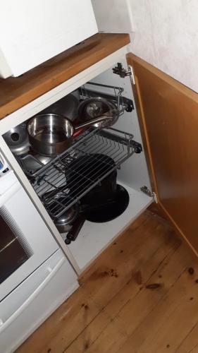 a stove top oven with a pot and pans in it at Romme Rum in Borlänge