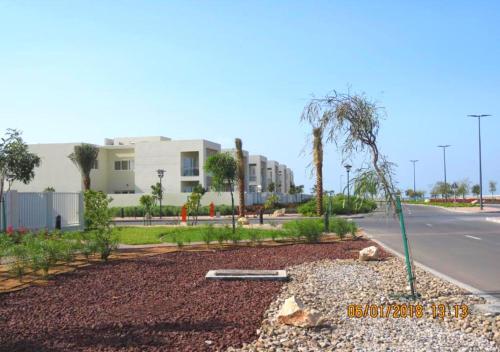 a street scene with a fire hydrant and a house at Holiday Home 3 bedroom Seaview in Ras al Khaimah