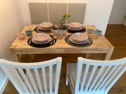 a wooden table with plates and dishes on it at Stadtgeflüster in Dessau
