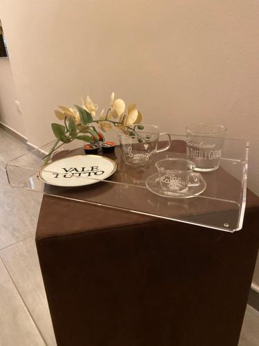 a glass table with bowls and dishes on it at La Maison Di Carla in Ancona