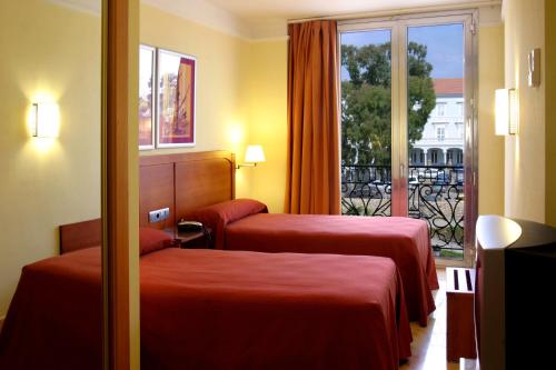Säng eller sängar i ett rum på Hotel Los Habaneros