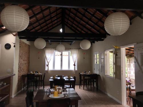 特雷索波利斯的住宿－Pousada HospedaBia，一间带桌子和吊灯的用餐室