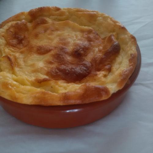 a pie in a red dish on a table at Le Relais des Cavaliers in Villeneuve-dʼEntraunes