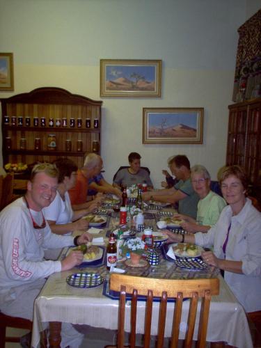 a group of people sitting around a table eating at Seeheim Hotel in Seeheim