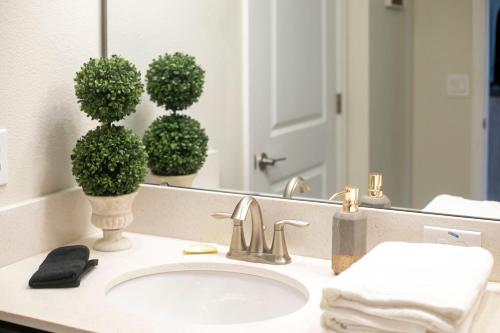 a bathroom counter with a sink and a mirror at B - New 4 Bedroom Home - 5 Miles to Disney - Free Water Park - Private Pool in Kissimmee