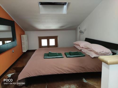 una camera da letto con un grande letto con due asciugamani verdi di La Ciammarica a Sulmona