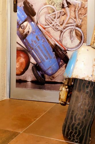 a picture of a painting with a motorcycle helmet on a floor at Les chambres atypiques de Nico Bush - Parking sécurisé vélos in Tournai