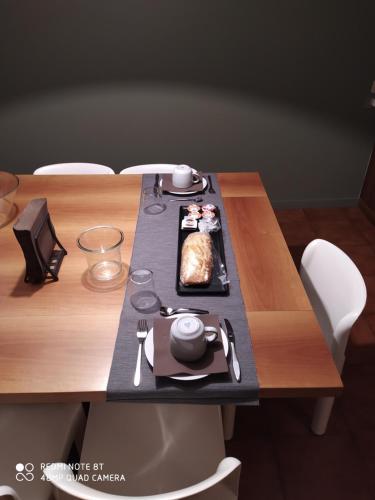 a wooden table with a plate of food on it at Dolomitiloungebelluno Mountain resources in Belluno