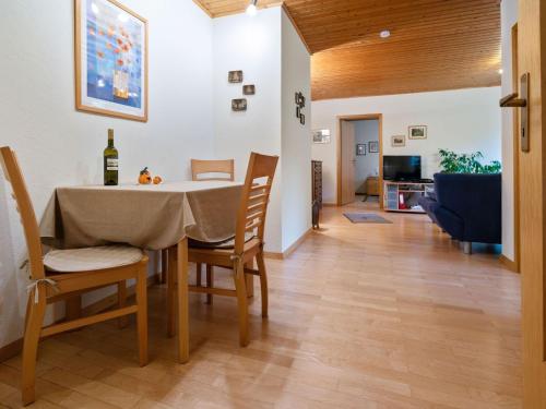 a dining room and living room with a table and chairs at Holiday home in Kyllburg Eifel near the forest in Kyllburg