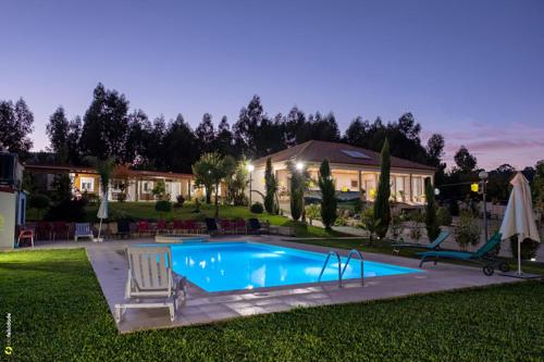 a swimming pool in the yard of a house at Alojamento Costa & Dias in Vila Verde