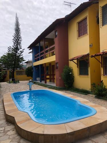 a swimming pool in front of a house at Privê paraíso do mar in Porto De Galinhas