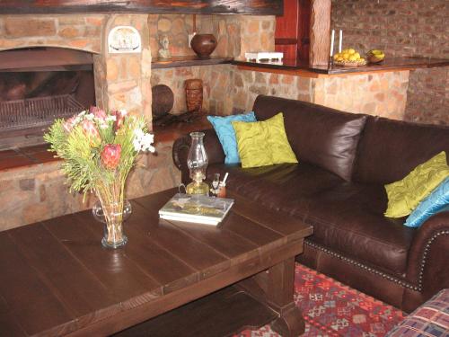 a living room with a couch and a fireplace at Intaba Lodge in Kirkwood