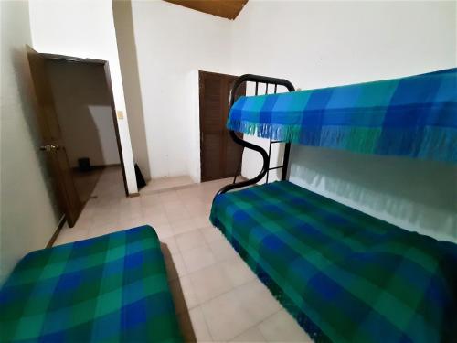 a blue and green couch in a room at Condominio El Portal Casa 1 in Carmen de Apicalá